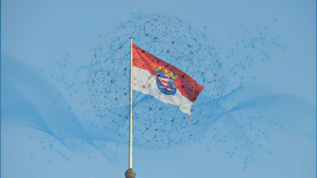 Composite photo of the flag of Hesse and a ball with data connections for the Common Data Space Historical Heritage in Hesse